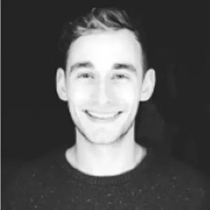 Black and white picture of Max May smiling at camera