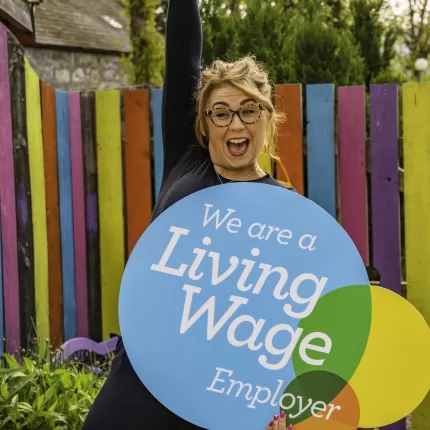 Woman from Living Wage Employer with sign