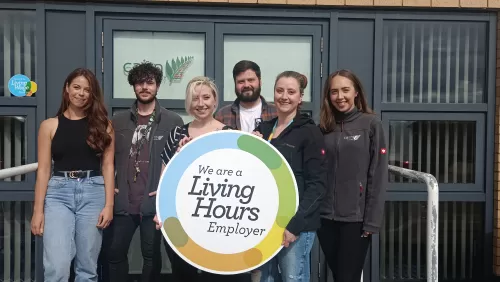Cairn Ecology employees with Living Hours logo 