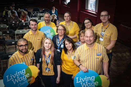 Ikea staff with Living Wage logos in Manchester