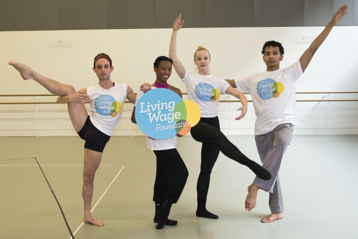 Dancers holding the Living Wage logo