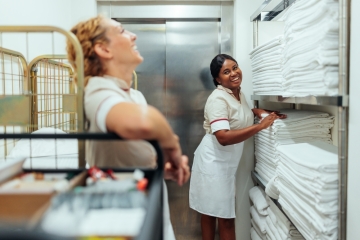 Women working in cleaning with sheets
