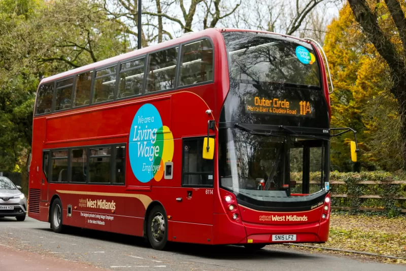 Living Wage logo on red bus