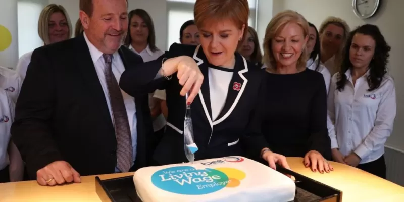 Nicola Sturgeon cutting Living Wage logo cake